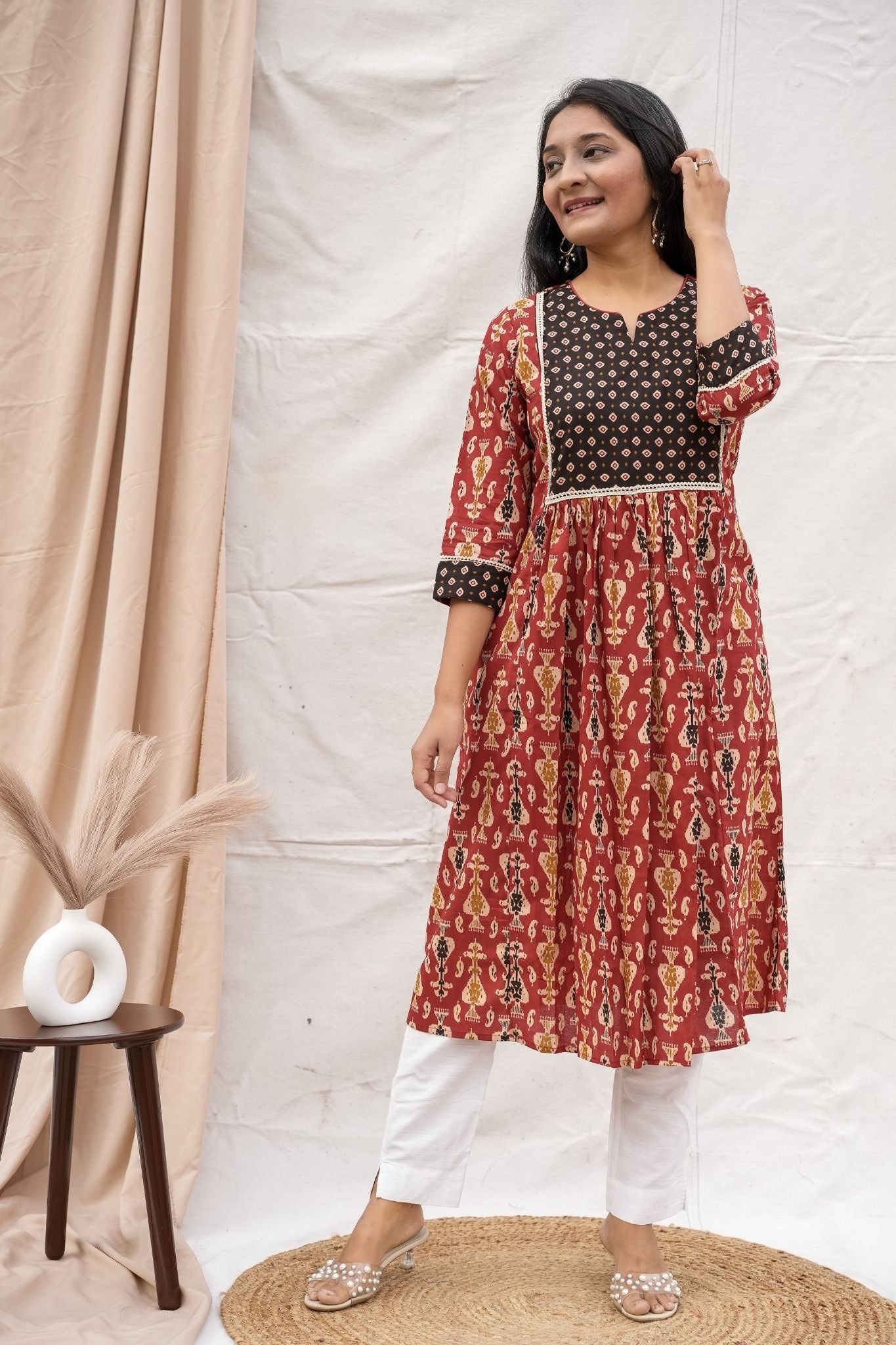 Full look of rust nursing and feeding friendly kurta showing V neck and fabric border detailing