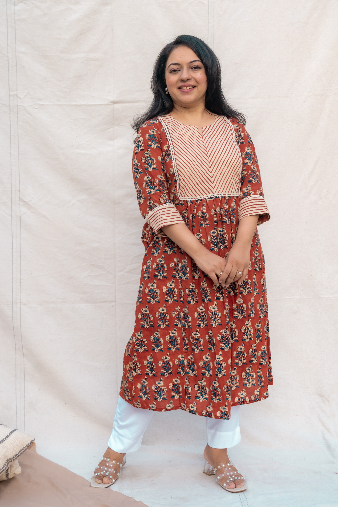 Full look of rust hand block A-line nursing and feeding friendly kurta with crochet lace detailing , fabric patch and sleeve detailing