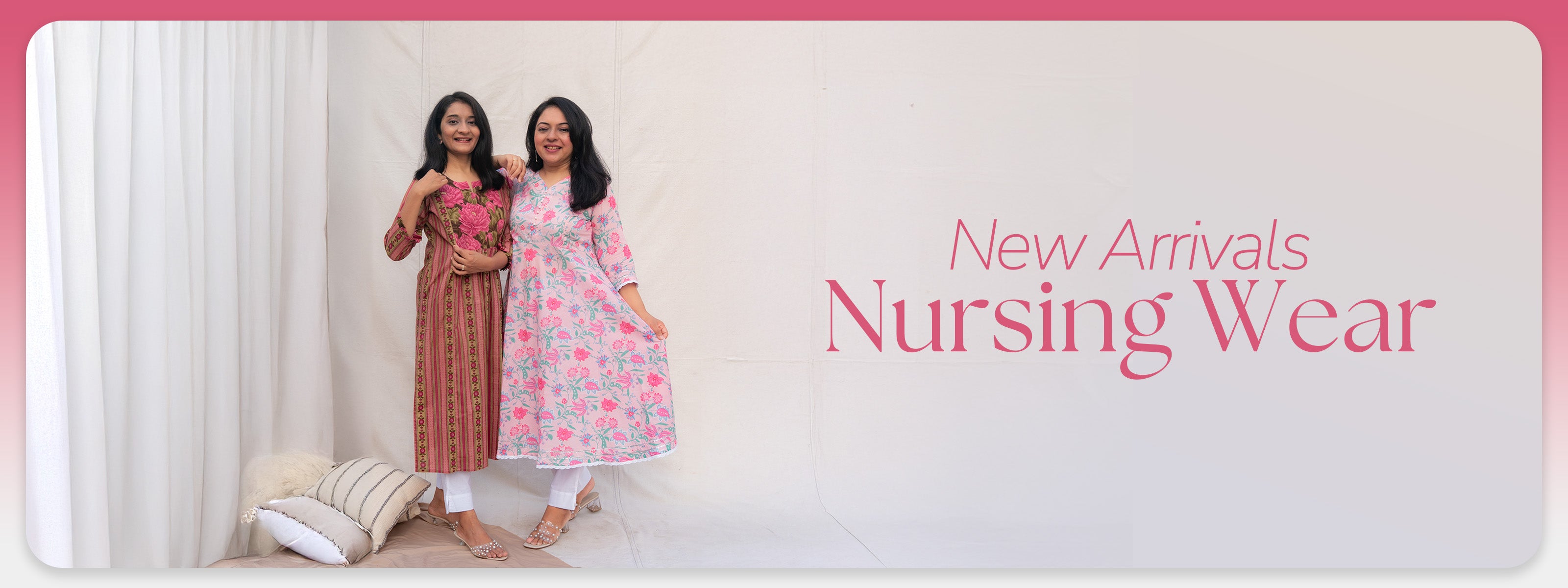 Two women in nursing wear standing against a white curtain with New Arrivals Nursing Wear text.