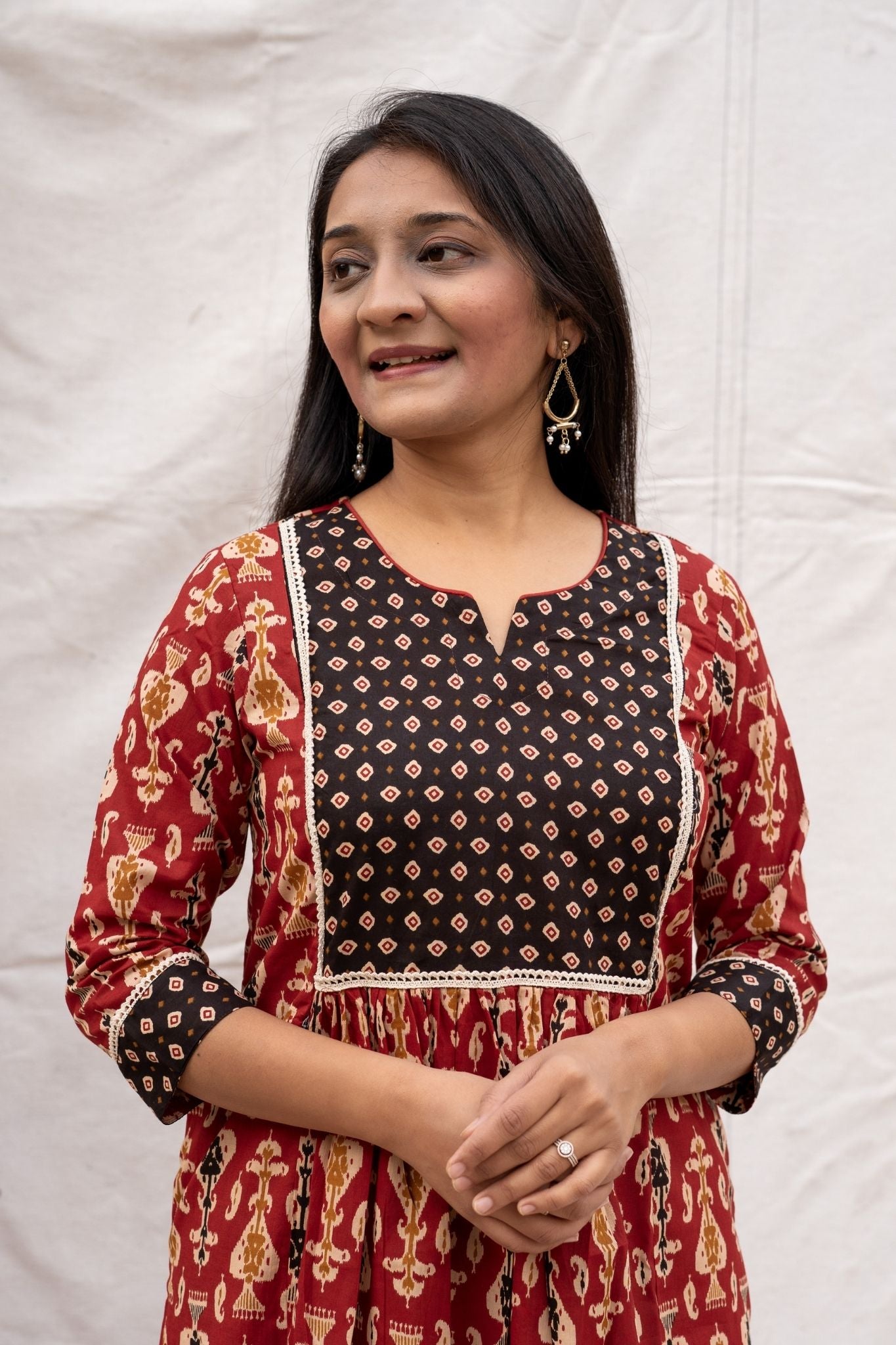 Close up view of rust nursing & feeding friendly kurta showing lace border